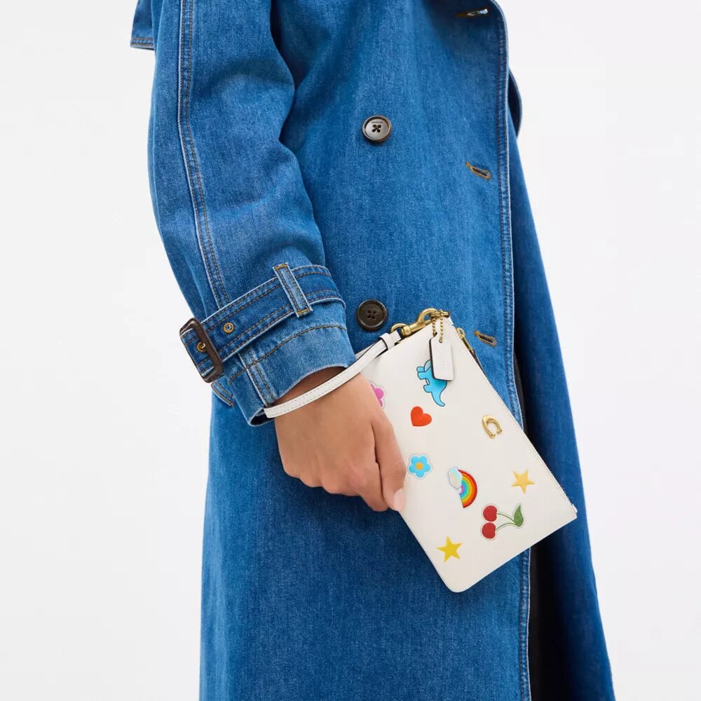 Essentiële kleine polbandtas met stickerprint