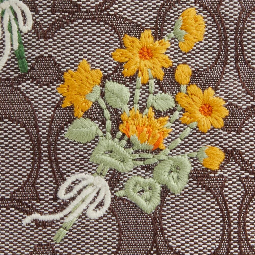Faye Minitas met trekkoord in kenmerkend jacquard met bloemenborduursel