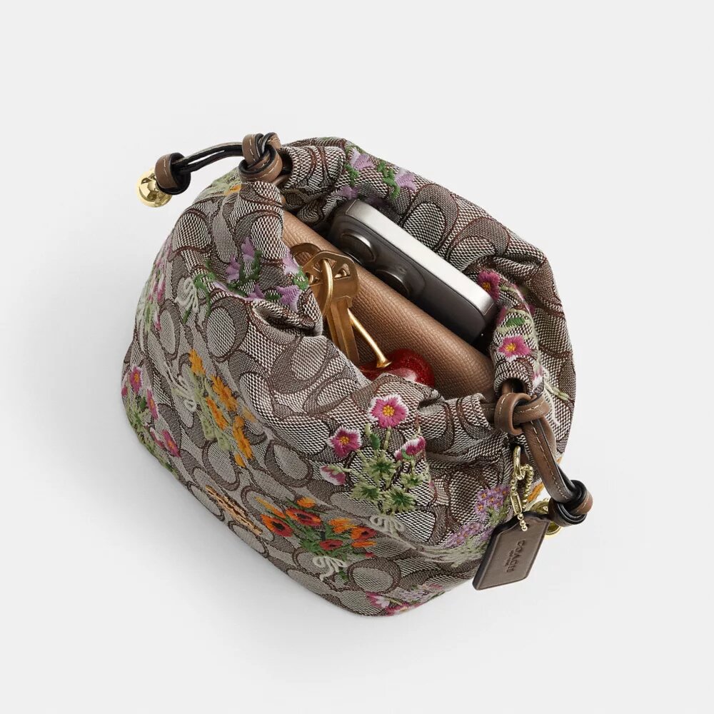 Faye Minitas met trekkoord in kenmerkend jacquard met bloemenborduursel