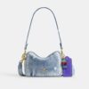 Mini Carey-crossbodytas in ‘Loved Denim’ met bedels