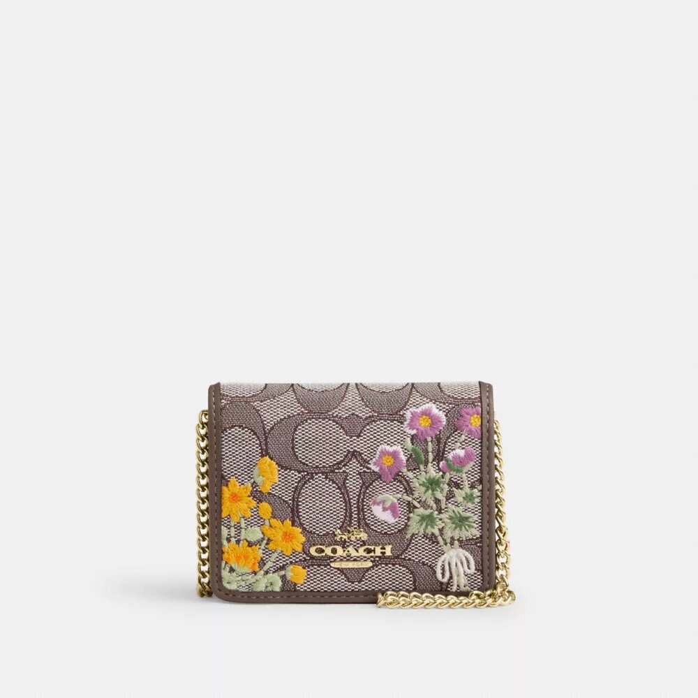 Miniportemonnee aan een ketting van kenmerkend jacquard met bloemenborduursel