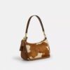 Teri-schoudertas van haarkalfsleer met koeienprint